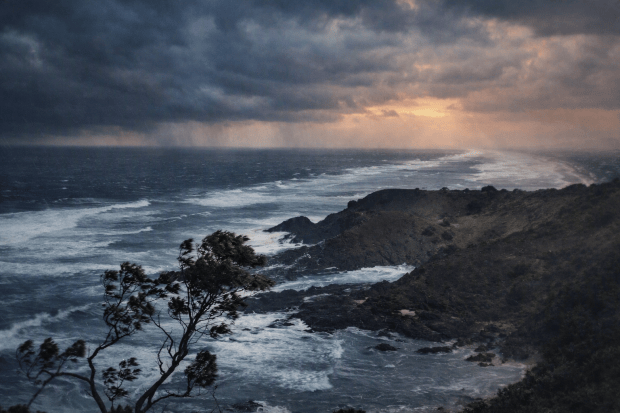 A colourised photograph of rough seas on the shore of Moreton Island, used to illustrate the dangers that the steamer Sovereign and other vessels faced during heavy weather.